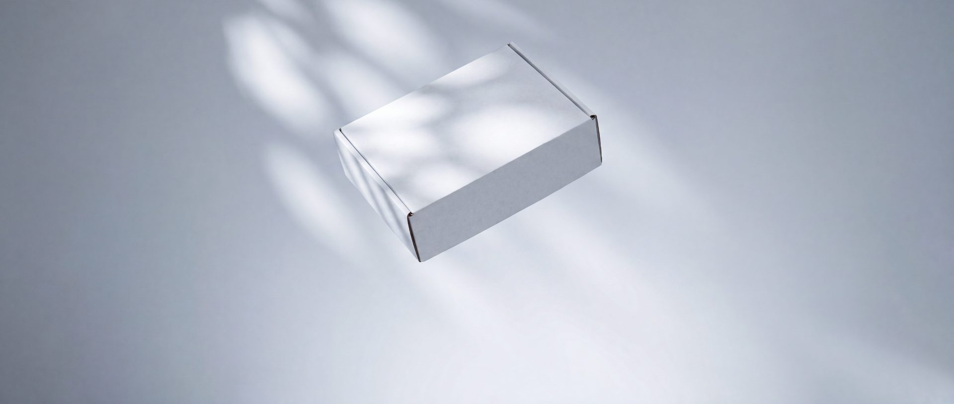 An unmarked plain package on a grey surface